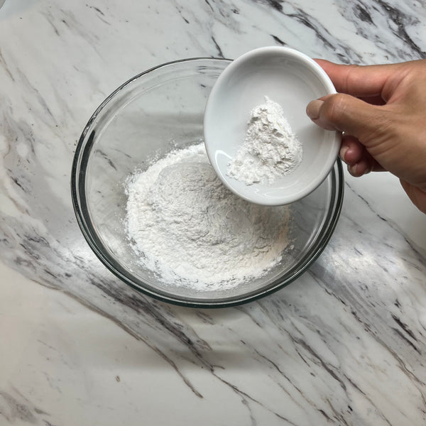 adding the dry ingredients to a bowl